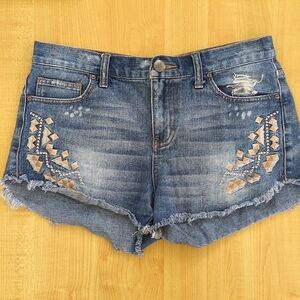 Free People distressed medium wash embroidered denim cut-off shorts